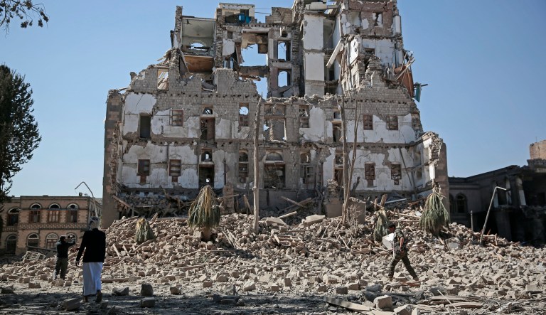 Houthi Shiite rebels walk amid the rubble of the Republican Palace that was destroyed by Saudi-led airstrikes, in Sanaa, Yemen, Wednesday, Dec. 6, 2017. Former President Ali Abdullah Saleh was killed on Monday by his onetime allies, the Iran-backed Houthis. Sanaa has witnessed heavy fighting since last week between Saleh's loyalists and Houthis forcing many Yemenis to cower indoors fearing the violent street clashes. (AP Photo/Hani Mohammed)