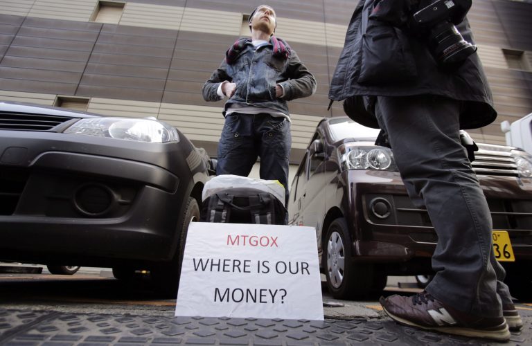 Bitcoin trader Kolin Burges stands in protest outside an office building housing Mt. Gox in Tokyo, Wednesday, Feb. 26, 2014. Prominent bitcoin supporters said the apparent collapse of the Tokyo-based Mt. Gox exchange was an isolated case of mismanagement that will weed out 