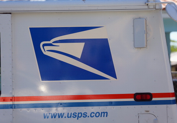 MIAMI, FL - NOVEMBER 15:  A U.S. Postal Service truck is seen on November 15, 2012 in Miami, Florida. The United States Postal Service reported a record annual yearly loss of $15.9 billion, more than triple the $5.1 billion loss last year.  (Photo by Joe Raedle/Getty Images)