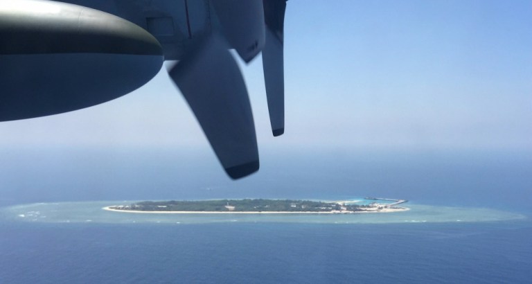 In particular, the report details the massive Chinese military buildup on islands, some man-made, in the East and South China Seas. (AP Photo)