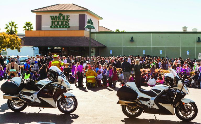 Glendale firemen hold up elementary school children on the parking lot waiting to reunite with their parents after their school was evacuated for a bomb threat in Glendale, Calif., Monday, Jan. 7, 2013. The bomb threat prompted the evacuation of hundreds of children from R.D. White Elementary School on Monday while police searched buildings to make sure the campus was safe. An anonymous caller phoned the school at around 8:30 a.m., and said there was a bomb at the campus, according to police Sgt. Tom Lorenz. (AP Photo/Damian Dovarganes)