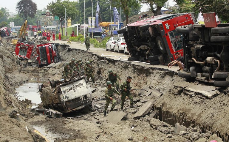 Soldiers use electronic sensors to search for missing persons believed to be buried after massive gas explosions in Kaohsiung, Taiwan, Friday, Aug. 1, 2014. A series of explosions about midnight Thursday and early Friday ripped through Taiwan's second-largest city, killing scores of people, Taiwan's National Fire Agency said Friday. (AP Photo/Wally Santana)