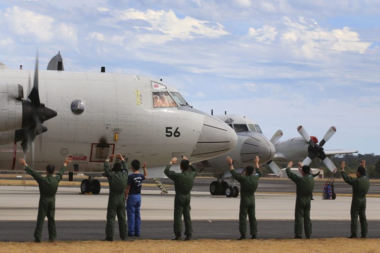 Japan Maritime Self-Defense Force farewell their P-3C Orion as it taxis from the Royal Australian Air Force Pearce Base to commence a search for possible debris from the missing Malaysia Airlines flight MH370, in Perth, Australia, Monday, March 24, 2014. Satellite images released by Australia and China had earlier identified possible debris in an area that may be linked to the disappearance of the flight on March 8 with 239 people aboard. (AP Photo/Paul Kane, Pool)