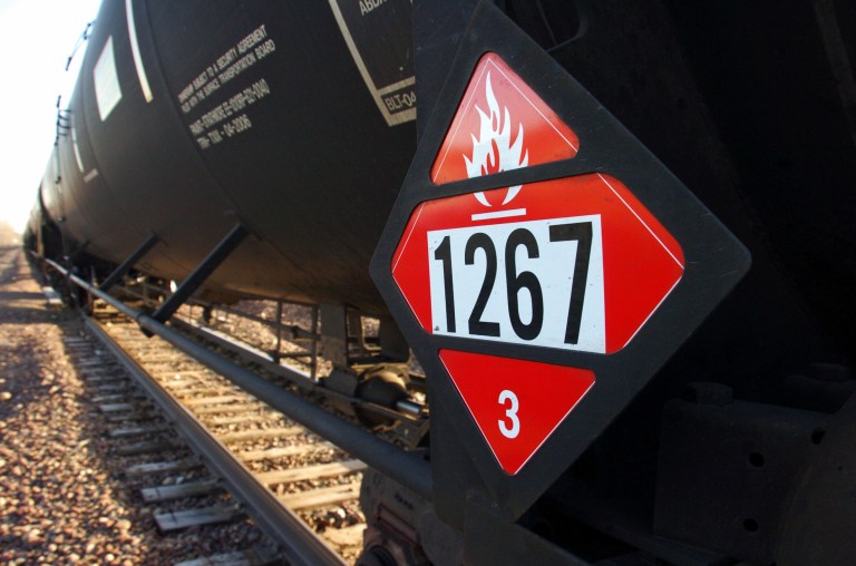 FILE - This Nov. 6, 2013 file photo shows a warning placard on a tank car carrying crude oil near a loading terminal in Trenton, N.D. North Dakota Public Service Commissioner Julie Fedorchak wants the state to employ its own railroad safety inspectors to help monitor crude shipments coming from the oil patch. Fedorchak says the idea is aimed at preventing accidents like the fiery oil train crash outside Casselton in December that left an ominous cloud over the town and led some residents to evacuate. (AP Photo/Matthew Brown, File)