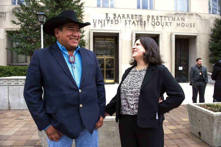 Chairman Harold Frazier, of the Cheyenne River Sioux Tribe, speaks with the tribe's attorney, Nicole Ducheneaux, as they leave the Federal Courthouse in Washington on Feb. 28. (AP Photo/Cliff Owen)