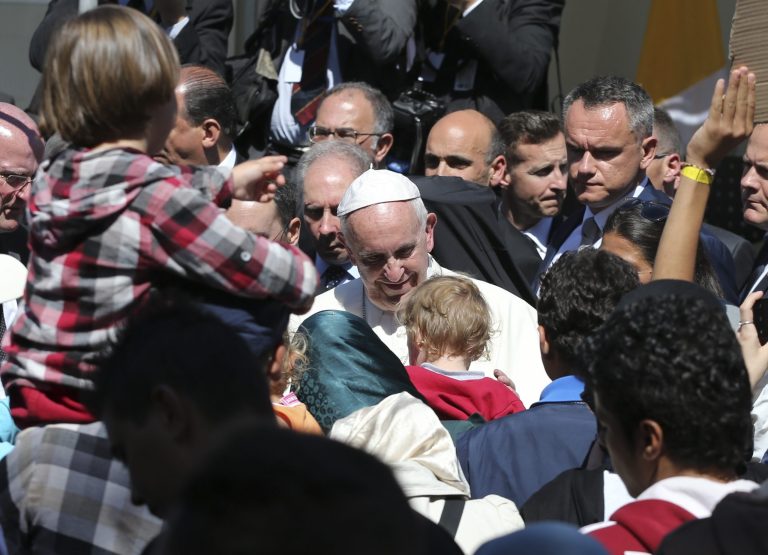 FILE - In this April 16, 2016 file photo, Pope Francis meets migrants at the Moria refugee camp on the Greek island of Lesbos. The pope, in his annual message for the World Day of Migrants and Refugees on Thursday, Oct. 13, 2016, denounced the forced repatriation of unaccompanied children migrants who flee wars and poverty, saying countries should try to meet their needs rather than return them to uncertain futures back home. (AP Photo/Petros Giannakouris, File)