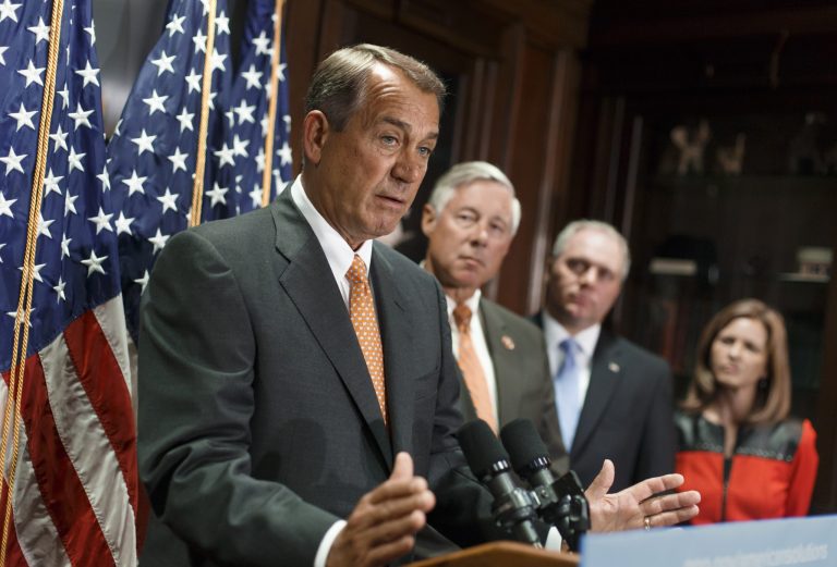 House Speaker John Boehner of Ohio, left, speaks during a news conference on Capitol Hill in Washington, Tuesday. Boehner said Tuesday that Islamic State militants pose a serious threat that must be dealt with in Iraq, Syria or wherever they exist as he pressed President Obama to spell out the U.S. strategy to destroy the militants. (AP Photo/J. Scott Applewhite)