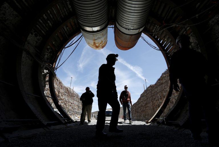 People walk into the south portal of Yucca Mountain during a congressional tour of the proposed radioactive waste dump near Mercury, Nev. Nevada's Board of Examiners has approved a $5.1 million contract with an outside legal team to help fight President Trump's proposal to restart the Yucca Mountain nuclear waste dump. (AP Photo/John Locher, File)