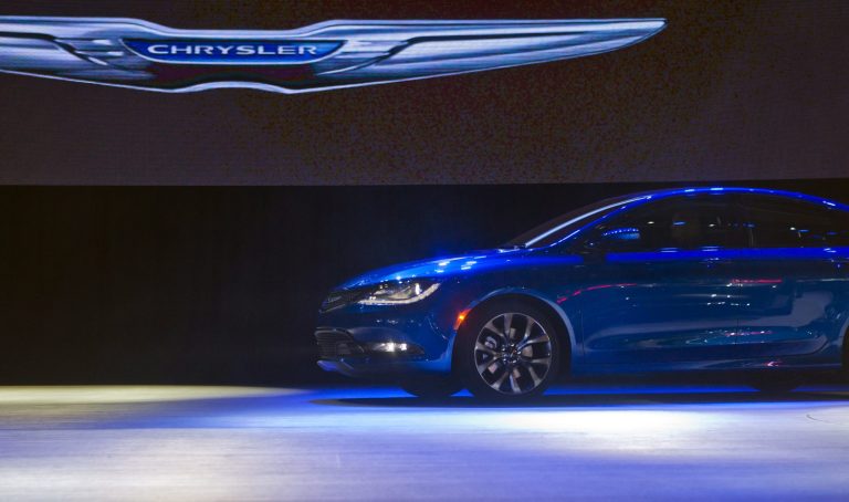 FILE - In this Monday, Jan. 13, 2014, file photo, a Chrysler 200 sedan drives on stage at its introduction,  at the North American International Auto Show in Detroit, Mich. Chrysler reports quarterly financial results before the market open on Wednesday, Jan. 29, 2014.  (AP Photo/Tony Ding)