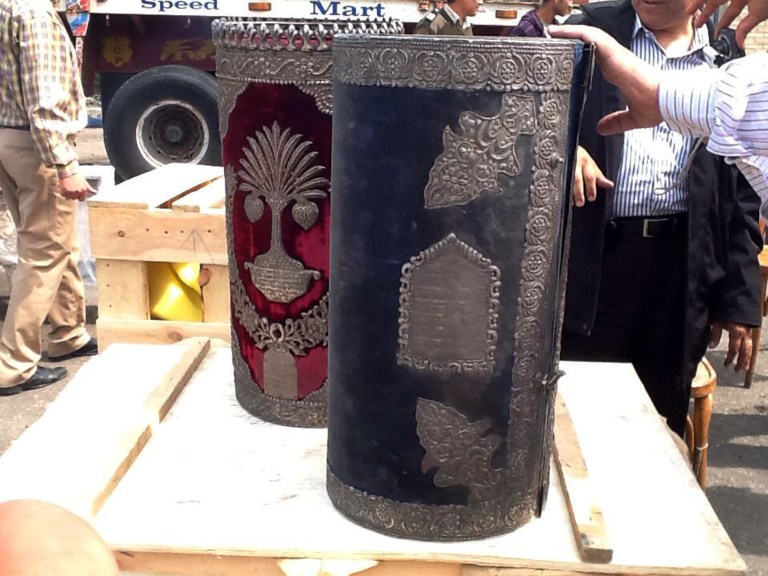 This image released by Egypt's Ministry of Antiquities on Friday, April 18, 2014 shows cylindrical boxes, part of a cache of Jewish religious artifacts seized by officials in Damietta, Egypt that smugglers wanted to ship to Belgium at one of the country's main ports. Antiquities Minister Mohammed Ibrahim said in a statement Friday that officials found the artifacts while searching cargo Thursday at the coastal city of Damietta. Among the artifacts are a cylindrical wooden box plated in silver, which would have held Torah scrolls. Officials also found a silver knife dating to roughly 1890 with inscriptions, and bells commonly hung in synagogues. (AP Photo/Egypt Ministry of Antiquities)