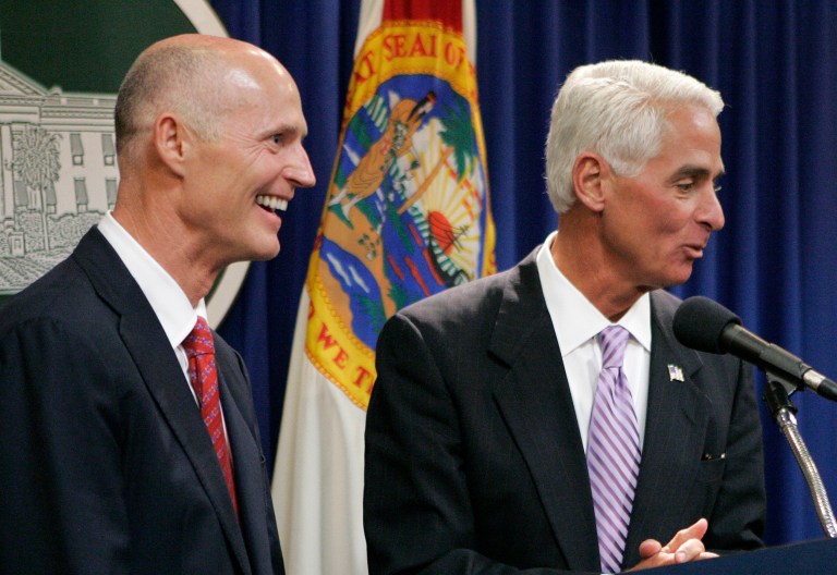 Gov. Rick Scott, left, and former Gov. Charlie Crist react to a question at a news conference on Nov. 9, 2010 in Tallahassee, Fla. (AP Photo/Steve Cannon)
