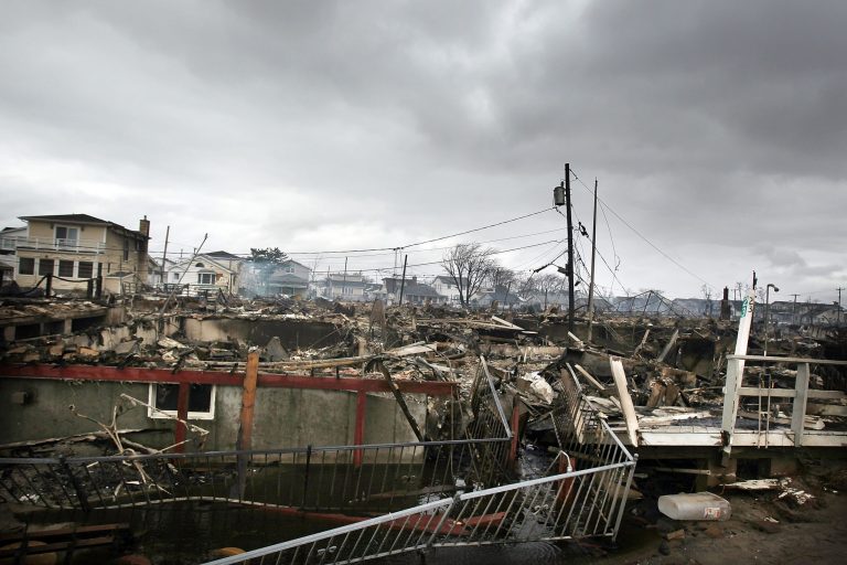 Homes sit smoldering after Hurricane Sandy on Oct. 30, 2012, in the Breezy Point Neighborhood of the Queens borough of New York City. (Photo by Spencer Platt/Getty Images)