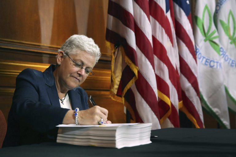 Environmental Protection Agency Administrator Gina McCarthy signs new regulations for power plants June 2, 2014 in Washington. (Photo by Chip Somodevilla/Getty Images)