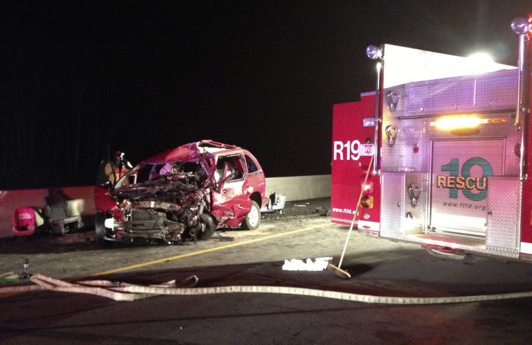   ADDS BYLINE - A person, left, takes photos of at the scene of a head-on collision involving two minivans on Interstate 75, Sunday, Dec. 23, 2012, near Franklin, Ohio. The collision killed four people, including a 7-year-old boy, from two different families in Ohio and Tennessee just two days before Christmas. Two other children were critically injured in the collision. (AP Photo/Dayton Daily News, Drew Simon) LOCAL PRINT OUT; LOCAL TV OUT; WKEF-TV OUT; WRGT-TV OUT; WDTN-TV OUT  