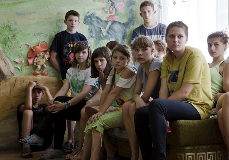 Children from Donetsk orphanage gather to speak to journalists in the city of Donetsk, eastern Ukraine Monday, July 14, 2014. The Donetsk People's Republic want to take about 130 orphans living in a Donetsk orphanage and send them to Russia. (AP Photo/Dmitry Lovetsky)