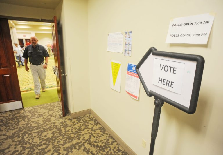 A man leaves the voting area after casting his ballot at the Oxford Conference Center in Oxford, Miss., on Tuesday. (AP Photo/ Bruce Newman)