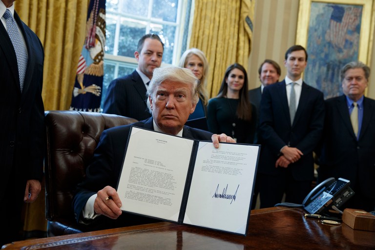President Trump signs an executive order authorizing Keystone XL, Dakota Access pipelines. (AP Photo/Evan Vucci)