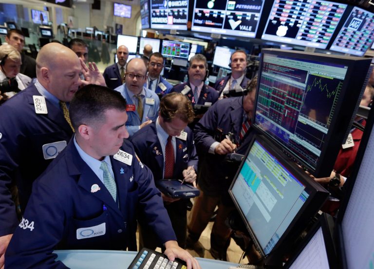 Specialists Michael O'Connor, left, and Matthew Diez, foreground left, work with traders at the post that handles US Steel, on the floor of the New York Stock Exchange Thursday, Oct. 17, 2013. Weak earnings from IBM and other major U.S. companies are dragging the stock market lower in early trading.  (AP Photo/Richard Drew)