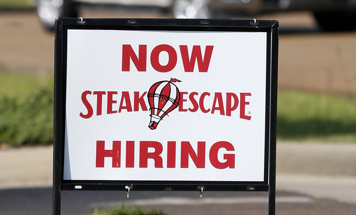 A hiring sign sits outside the Steak Escape restaurant in Flowood, Miss., Friday, Sept. 19, 2014. (AP Photo/Rogelio V. Solis)