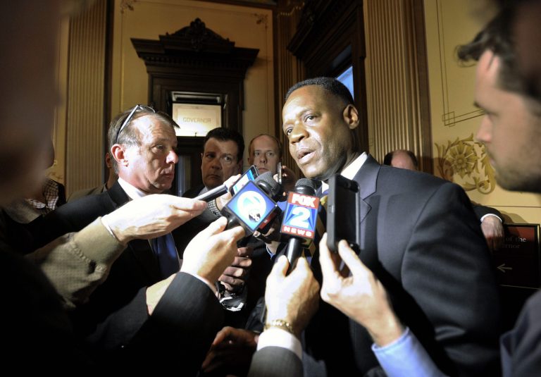 Detroit Emergency Manager Kevyn Orr, center, talks to reporters outside the Governor's office at the Michigan Capitol in Lansing, Mich., Tuesday, April 29, 2014. Orr made his first pitch of the cityâs debt-cutting plan to lawmakers Tuesday and planned to return to the Capitol on Wednesday for more meetings with legislative leaders. The Legislatureâs financial support is seen as crucial to getting retiree groups to settle their pension claims and speed Detroitâs exit from bankruptcy by October. (AP Photo/Detroit News, Dale G. Young)