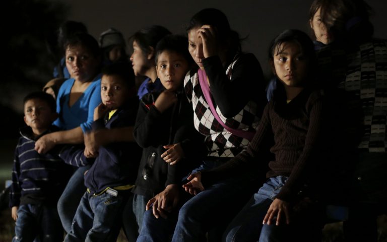 A group of immigrants from Honduras and El Salvador who crossed the U.S.-Mexico border illegally are stopped in Granjeno, Texas, in this June 25, 2014 photo. (AP Photo/Eric Gay)