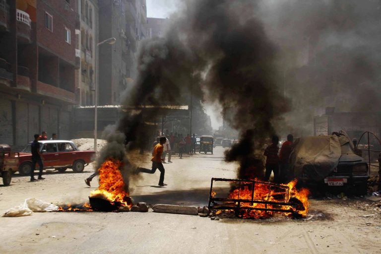 Egyptian supporters of ousted President Mohammed Morsi block a road by setting waste on fire in Matariya Square, Cairo, Egypt, Thursday, Aug. 14, 2014. Egyptian security forces firing tear gas quashed small, scattered demonstrations on Thursday by Islamist supporters of ousted President Mohammed Morsi who tried to commemorate the anniversary of the killing of hundreds of protesters. (AP Photo/Ahmed Abdel Fattah, El Shorouk Newspaper) EGYPT OUT