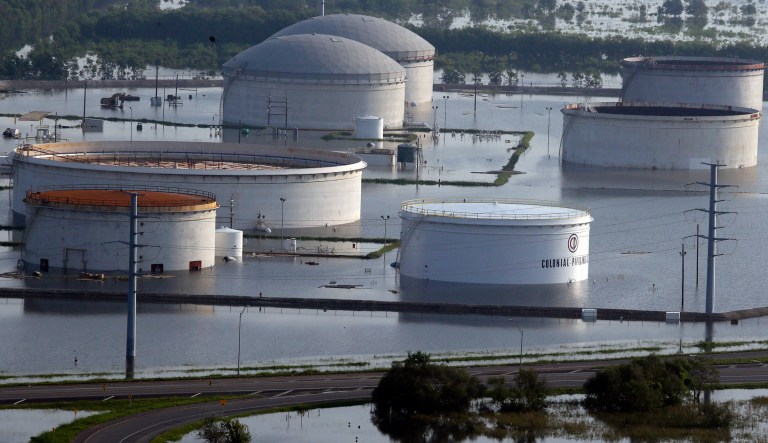 In this aerial photo, holding tanks for Colonial Pipeline Company sit in floodwaters caused Tropical Storm Harvey in Port Arthur, Texas, Friday, Sept. 1, 2017. (AP Photo/LM Otero)
