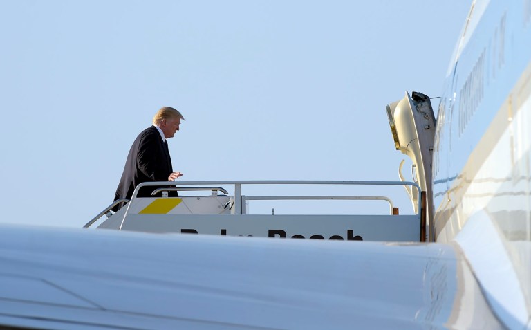 President Donald Trump walks up the steps the steps of Air Force One at Palm Beach International Airport in West Palm Beach, Fla. (AP Photo/Susan Walsh)