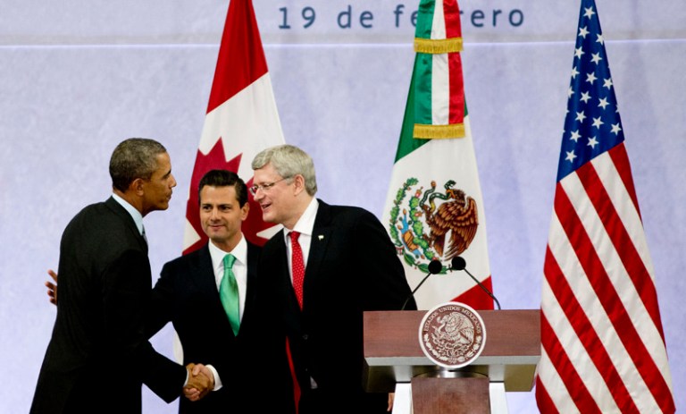 President Obama, left, Mexico's President Enrique Pena Nieto, center, and the Prime Minister of Canada, Stephen Harper, shake hands at the end of a news conference concluding the North American Leaders Summit in Toluca, Mexico. (AP/Eduardo Verdugo)