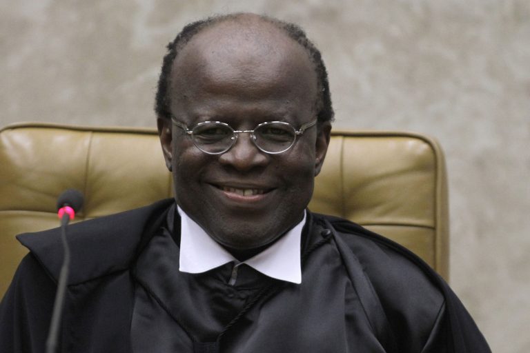 FILE - In this  Nov. 22, 2012 file photo, Brazil's Supreme Court President Joaquim Barbosa smiles during his inauguration ceremony at the Supreme Court in Brasilia, Brazil. Barbosa, Brazil's first and only black top court justice, is presiding over his last session as president of the Supreme Court on Tuesday, July 1, 2014. Barbosa announced his early retirement one month ago. (AP Photo/Eraldo Peres, File)