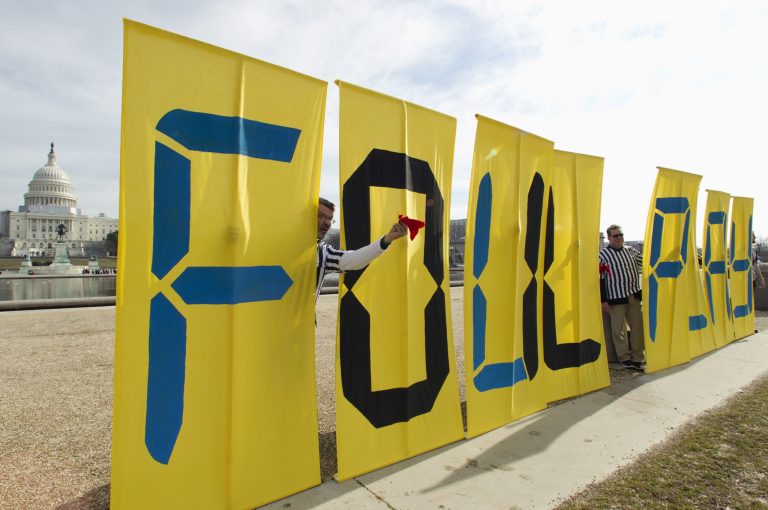   FILE - This Jan. 24, 2012 file photo shows protestors against the Keystone XL pipeline, dressed as referees, hold banners spelled 