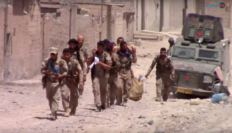 U.S.-backed Syrian Democratic Forces fighters in the eastern side of Raqqa, Syria. The SDF forces have breached the wall around Raqqa's Old City, the U.S. military said Tuesday, marking a major advance in the weeks-old battle to drive Islamic State militants out of their self-declared capital. (Furat FM, via AP)