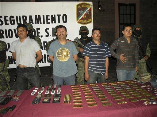 In this Dec. 11, 2009 photo obtained by the AP, suspects are shown to the press at the 12th Military Zone in San Luis Potosi, Mexico. Among the suspects is Julian Zapata Espinoza aka ?El PiolÃ­n?, third from left. Zapata Espinoza was shown to the press on Wed., Feb. 23, 2011 after his arrest for allegedly being the main suspect in the Feb. 15 killing of U.S. Immigration and Customs, agent Jaime Zapata and injuring ICE agent Victor Avila. 