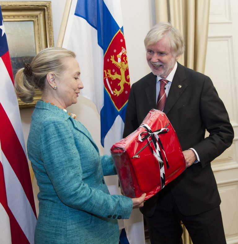   FILE - In this June 27, 2012 file-pool photo, then-Secretary of State Hillary Rodham Clinton receives a gift from Finnish Foreign Minister Erkki Tuomioja at the Government Banquet Hall in Helsinki, Finland. Former Secretary of State Hillary Rodham Clinton has outpaced President Barack Obama when it comes to lavish gifts from foreign leaders. State Department documents released Friday show Clinton got gold jewelry worth a half-million dollars from King Abdullah of Saudi Arabia, while Obamaâs most expensive gift was a $16,500 gold-plated clock from Crown Prince Salman bin Abdulaziz al-Saud, the Saudi defense minister. The gifts were among a bounty of vases, watches, art work and other items given to top U.S. officials in 2012, according to the departmentâs Office of Protocol, which catalogs the gifts and publishes an annual listing. (AP Photo/Haraz N. Ghanbari, Pool)  