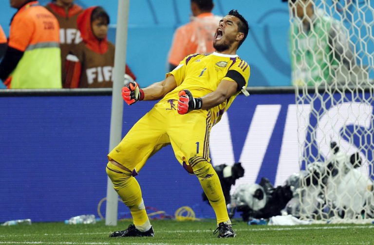 Argentina's goalkeeper Sergio Romero celebrates after he saved shot by Netherlands' Wesley Sneijder from the spot during the World Cup semifinal soccer match between the Netherlands and Argentina at the Itaquerao Stadium in Sao Paulo, Brazil, Wednesday, July 9, 2014. Argentina beat the Netherlands 4-2 in a penalty shootout to reach the World Cup final. (AP Photo/Frank Augstein)