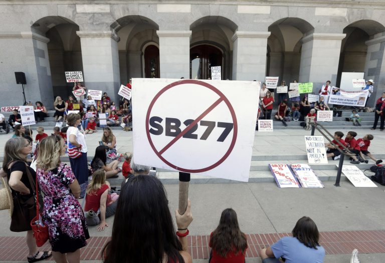 Opponents of a measure requiring nearly all California school children to be vaccinated gathered on the west steps of the Capitol after lawmakers approved the bill, in Sacramento, Calif., Thursday, June 25, 2015. (AP Photo)Â 