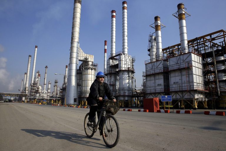 In this Monday, Dec. 22, 2014 photo, an Iranian oil worker rides his bicycle at the Tehran's oil refinery south of the capital Tehran, Iran. (AP Photo)Â 