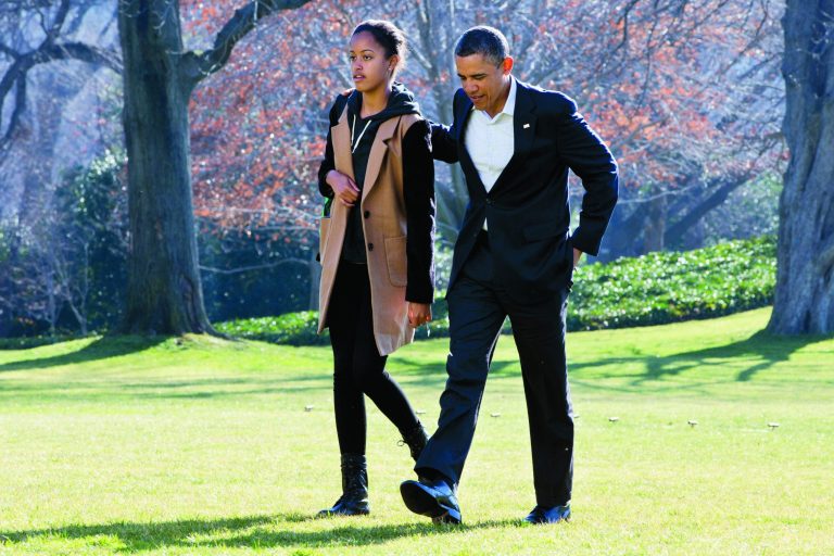 President Barack Obama walks with daughter Malia on the first family's return from vacationing in Hawaii, on the South Lawn of the White House in Washington, Sunday, Jan. 6, 2013. (AP Photo/Jacquelyn Martin)