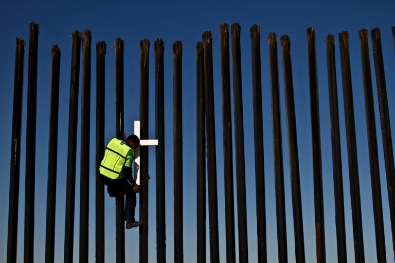 A deported migrant climbs the US-Mexico border fence in February 2011. Conservatives want the border secureÃÂ beforeÃÂ moving on broader immigration reform. (AP Photo/Guillermo Arias)