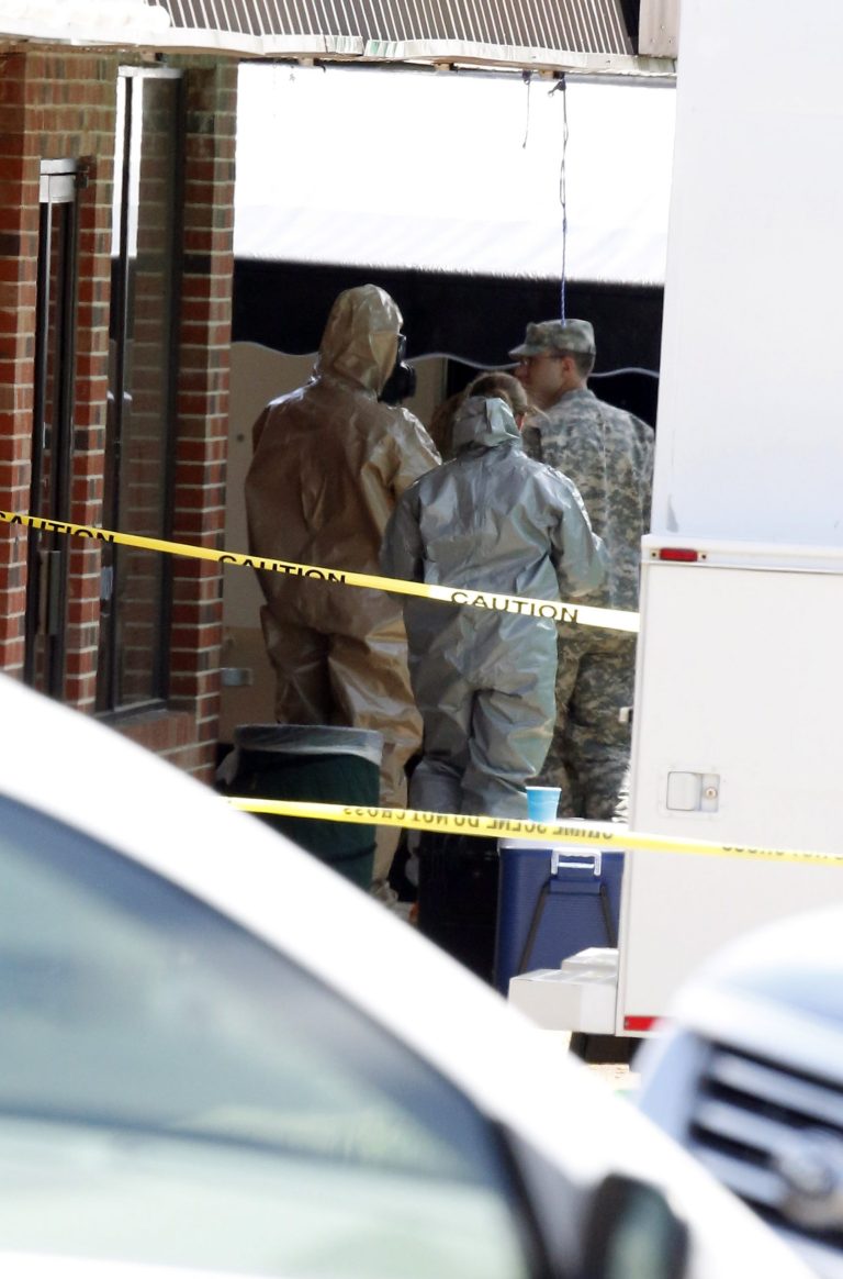 Federal authorities, some in hazmat suits search at a small retail space where neighboring business owners said Everett Dutschke used to operate a martial arts studio. Wednesday, April 24, 2013 in Tupelo, Miss., in connection with the recent ricin attacks. No charges have been filed against Dutschke and he hasn't been arrested. (AP Photo/Rogelio V. Solis)