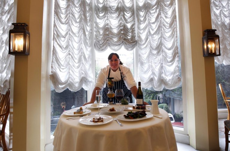   In this Dec. 7, 2012 photo, executive chef Kristin Butterworth poses for a photograph with her reveillon menu at the Grill Room of the Windsor Court Hotel in New Orleans. Roughly 50 restaurants in New Orleans are reviving an old Creole custom called reveillon, which stems from the old French tradition of eating a lavish meal after midnight Mass on Christmas Eve. (AP Photo/Gerald Herbert)  