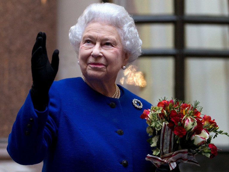 FILE - In this Tuesday, Dec. 18, 2012 file photo, Britain's Queen Elizabeth II looks up and waves to members of staff of The Foreign and Commonwealth Office as she ends an official visit which is part of her Jubilee celebrations in London. Queen Elizabeth has been taken to the King Edward VII hospital in central London suffering from gastroenteritis, Sunday, March 3, 2013. A palace spokesman said she was expected to stay in hospital for two days and all engagements for this week will be either postponed or cancelled.(AP Photo/Alastair Grant Pool, file)