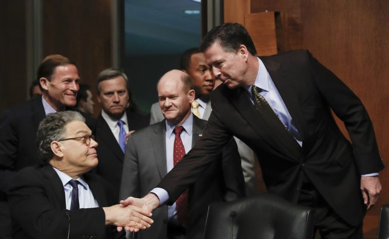FBI Director James Comey shakes hands with Senate Judiciary Committee member Sen. Al Franken, D-Minn. Washington, Wednesday, May 3, 2017, to testify. (AP Photo/Carolyn Kaster)