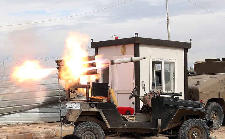 Members of an Iraqi Shiite militant group called Imam Ali Brigades launch rockets against Islamic State extremist positions during clashes in Tikrit, 130 kilometers (80 miles) north of Baghdad, Iraq, Tuesday, March 24, 2015. (AP Photo/Khalid Mohammed)