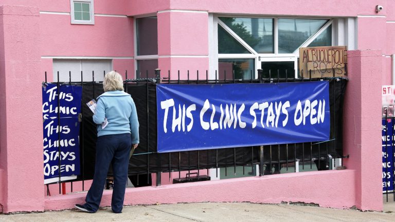 This Nov. 21, 2013 file photo shows anti abortion protester Mary McLaurin calling out to a patient hidden on the other side of a sign outside the Jackson Women's Health Organization clinic in Jackson, Miss.Â The Supreme Court could announce Monday, or sometime after that, whether it will scrutinize a law that would effectively gut Mississippi's last remaining abortion clinic.Â (AP Photo/Rogelio V. Solis, File)