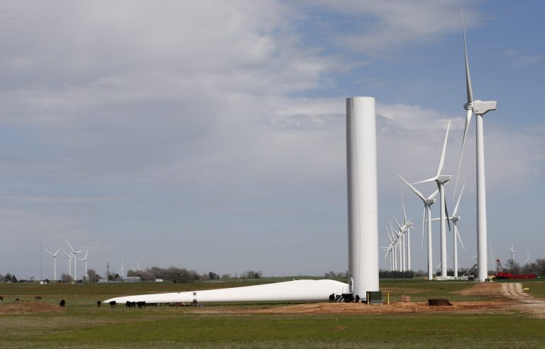 Cows are dwarfed by the equipment at a wind farm near Calumet, Okla., on April 12. (AP Photo/Sue Ogrocki)