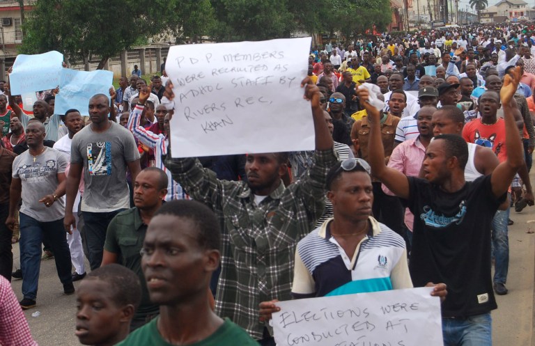 People take part in a demonstration to protest against the voting irregularities in the presidential election, in Port Harcourt, Nigeria, Sunday March 29, 2015. In the southern oil-producing center of Port Harcourt, thousands of Nigerians took to the streets to protest alleged killings of opposition campaign workers and voting irregularities. (AP Photo)