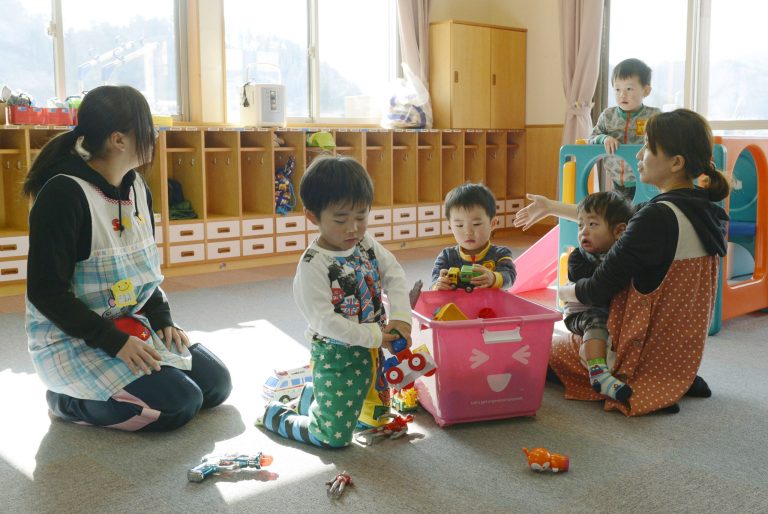 Toddlers play at a nursery school in Tamura, Fukushima Prefecture, northeastern Japan, Tuesday, April 1, 2014 after authorities allowed residents to return to live in their homes within a tiny part of a 20-kilometer (12-mile) evacuation zone around the Fukushima plant for the first time since Japan's nuclear disaster three years ago. The decision, which took effect Tuesday, applies to 357 people in 117 households from a corner of Tamura city after the government determined that radiation levels are low enough for habitation. (AP Photo/Kyodo News) JAPAN OUT, MANDATORY CREDIT