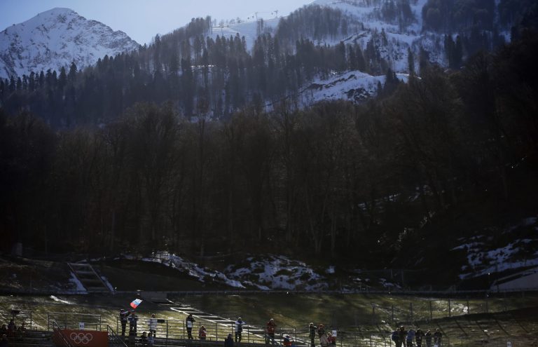 A spectator waves a RUssian flag during the ski jumping portion of the Nordic combined at the 2014 Winter Olympics, Wednesday, Feb. 12, 2014, in Krasnaya Polyana, Russia. (AP Photo/Gregorio Borgia)