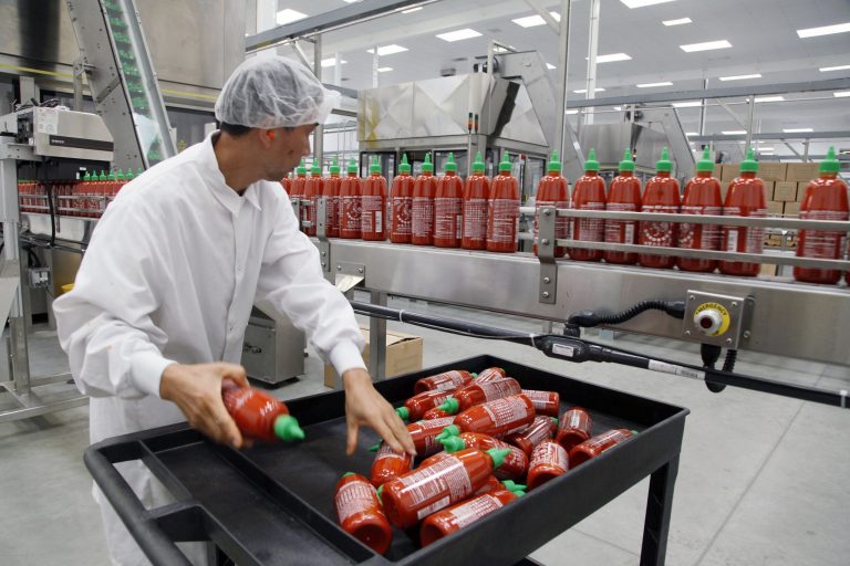 FILE - In this Oct 29, 2013 file photo, Sriracha chili sauce is produced at the Huy Fong Foods factory in Irwindale, Calif. The Commerce Department reports on wholesale prices for November on Friday, Dec. 13, 2013. (AP Photo/Nick Ut, File)
